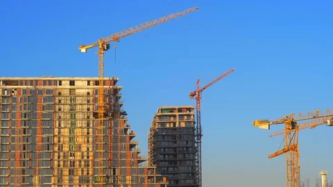 Crane machine work in sunny day against blue sky Stockbeeldmateriaal 84022604