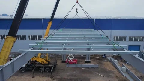Crane A modern metal frame is lowered on a crane for a roof construction site. d Stock Footage 172129181