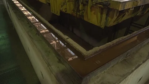 Crane move down fabricated concrete slab to the drying chamber. Production of Stock Footage 129632925