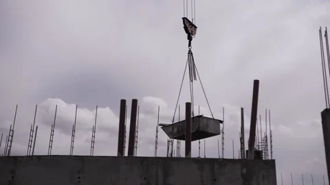 Crane moves cargo against the background of cloudy sky Stock Footage 178125007