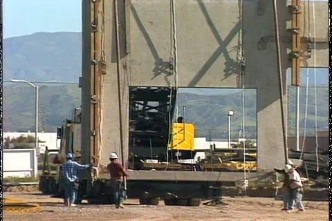 CRANE MOVES GIANT WALL Stock-Footage 1049713