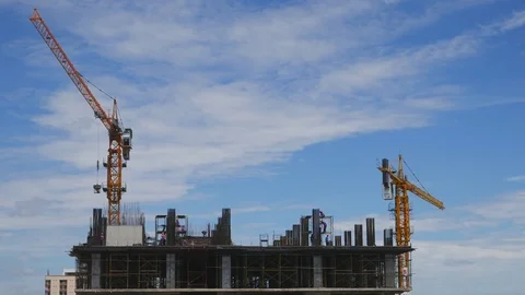 Crane moving construction panel with blue sky Stock Footage 77578478