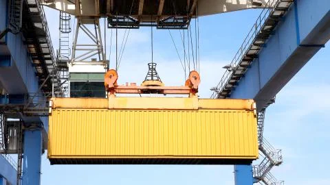 Crane moving a Shipping Container to a storage platform. Stock Photos