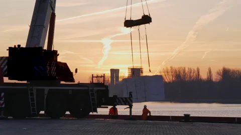 Crane offloading pulp from ship, truck passing by Stock Footage 294350511