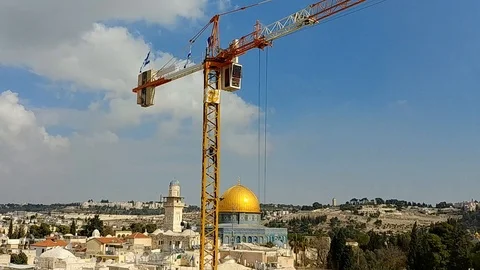 Crane operator descends from a crane, Dome of the Rock &amp; the Western Wall Stock Footage 98279578