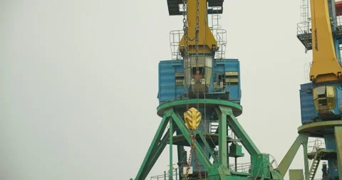 The crane operator manages the unloading of cast iron in the port. Business Stock Footage 197033569