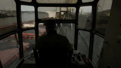 Crane operator spends his working day in cab. Control room with with levers Stock Footage 205229215