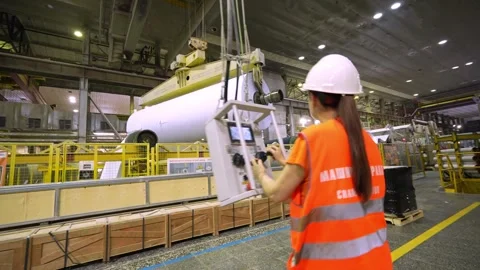 The crane operator unloads the finished paper in a roll from the paper machine 스톡 동영상 301969592