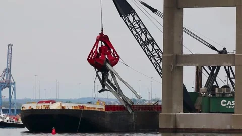 Crane placing large section of Key Bridge onto barge for removal Stock Footage 273563464