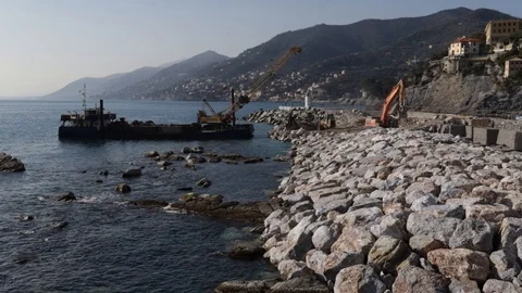 Crane on pontoon moves rocks on the pier 05 Stock Footage 108658178