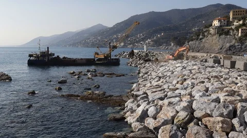 Crane on pontoon moves rocks on the pier 07 Stock Footage 108683545