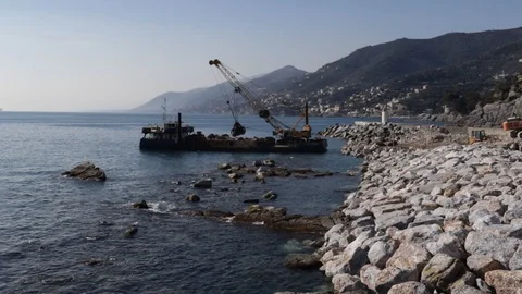 Crane on pontoon moves rocks on the pier 01 Stock Footage 108686193