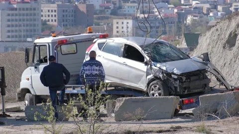 A crane pulled the wrecked car out of a deep hole. Evacuator. The victim of the Vidéo 144773517