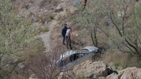 A crane pulled the wrecked car out of a deep hole. Evacuator. The victim of the Vidéo 145576399