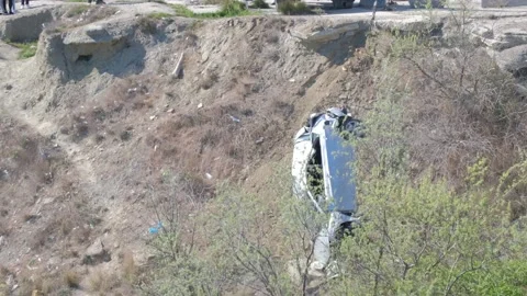 A crane pulled the wrecked car out of a deep hole. Evacuator. victim of the Vidéo 145576718