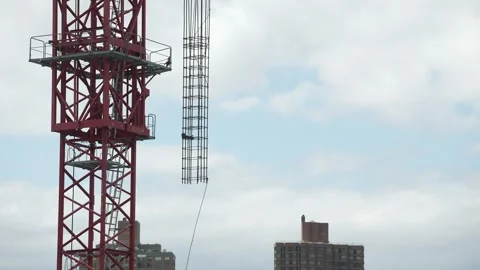 Crane pulling metal supporters for new buildings in Megapolis Stock Footage 241915915