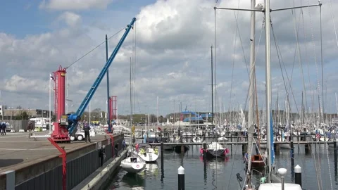 Crane pulling a sailing boat out of the water in the marina in Schilksee in G Stock Footage 153817013