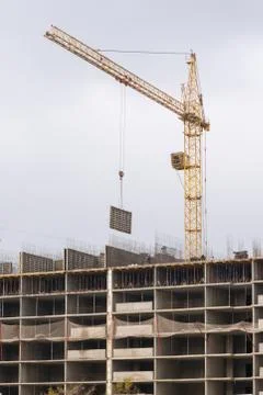 Crane raised formwork on construction of multi-storey residential building Stock Photos