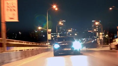 Crane rolling shot of a BMW 7 Series luxury car driving on a bridge at night Video stock 125523882