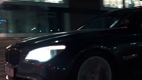 Crane rolling shot of a BMW 7 Series luxury car driving on a bridge at night Stock-Footage 125524270