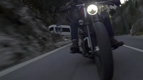 Crane rolling shot of a motorcycle driving on a mountain road during autumn Video stock 122644993