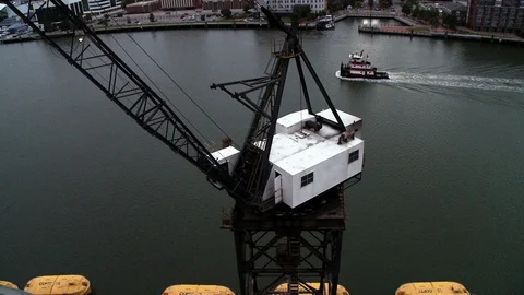 Crane on sea platform near cruiseship harbor loading boat dock Stock Footage 123728034