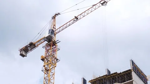 Crane. Self-erecting crane over a construction site. Crane near the building. Un Stock Footage 253656002