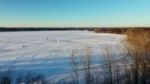 Crane shot with a drone coming down behind naked trees in winter Stock Footage 164252703