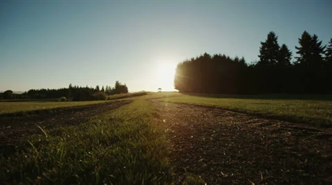 Crane Shot of Man Walking Into Sunset on Farm 2 Stock Footage 34372895