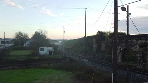 Crane shot over mist covered train tracks at sunrise Stock Footage 209145934