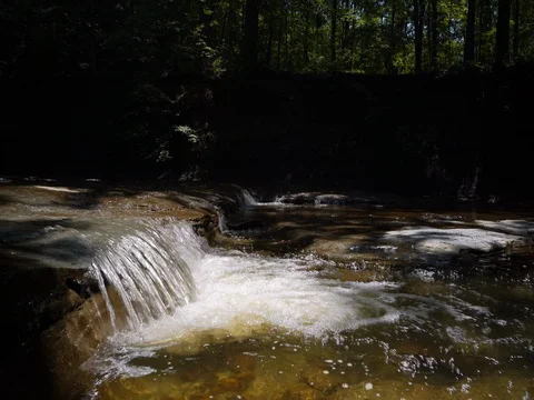 Crane shot over small waterfall in ohio stream Stock Footage 77152278