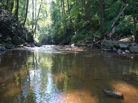 Crane shot over small waterfall in ohio stream Stock Footage 77156862