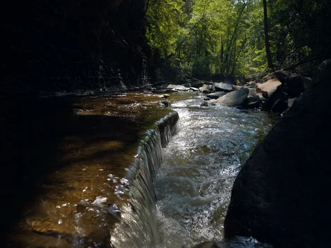 Crane shot over small waterfall in ohio stream Stock Footage 77159980