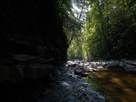 Crane shot over small waterfall in ohio stream Stock Footage 77159989