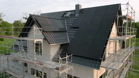 Crane shot of a single family house with solar panels under construction Video stock 242024948