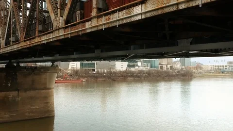Crane shot up of train crossing bridge in large urban area Stock-Footage 100416588
