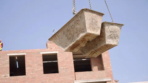 A crane is shown lifting various objects, including buckets, bricks, and a metal Stock Footage 270223625