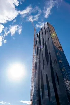 Crane on skyscraper Stock Photos