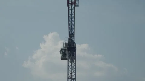 Crane Slowly Rotating on Construction Site Stock Footage 283119672