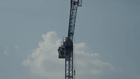 Crane Slowly Rotating on Construction Site Stock Footage 283119697