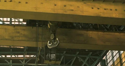 Crane slowly swinging on ceiling of old factory Stock Footage 129850537