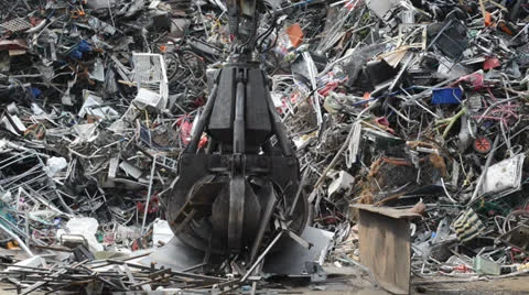 Crane sorting through scrap metal at scrapyard united kingdom Stock Footage 25596672