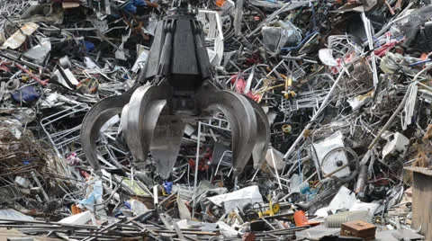 Crane sorting through scrap metal at scrapyard united kingdom Stock Footage 25596705
