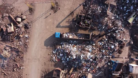 Crane sorting through scrap metal at scrapyard Stock Footage 235613172