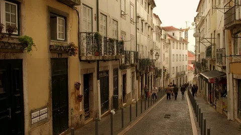 Crane style move down of people walking street in Alfama district, Lisbon Stock Footage 116170405