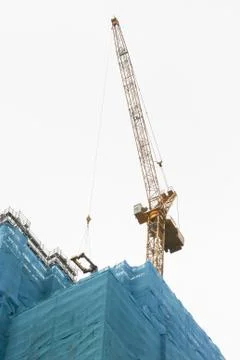 Crane on top of skyscraper Stock Photos