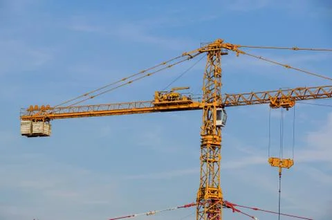 Crane tower on sky background at construction site Stock Photos