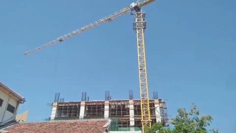 Crane tower work with blue sky in the background Stock Photos