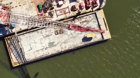Crane transporting container removed from MV Dali ship onto barge Stock Footage 271233933