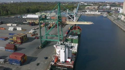 Crane unloading cargo ship at container terminal port Stock Footage 130594670